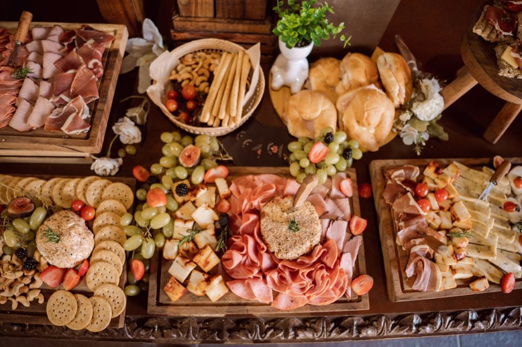 A beautifully arranged charcuterie board with meats, cheeses, fruits, and bread for catering events.